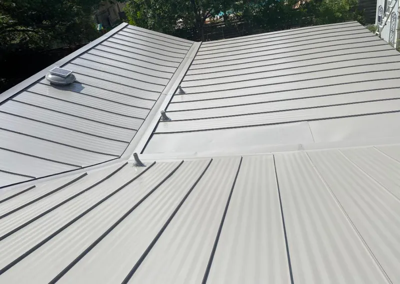 Solar attic fan installed on a metal roof for Roof Ventilation in Epsom